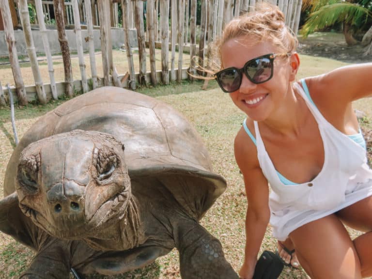 lady and giant tortoise in the Seychelles
