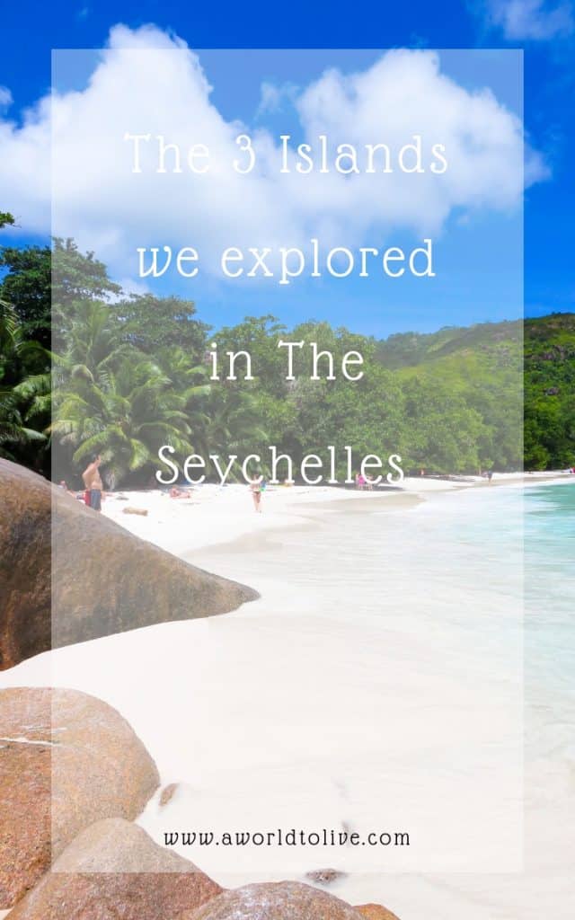 Looking down the shoreline of the beach. Behind the sand there's granite rocks and palm trees. Text over photo; The 3 Islands we explored in the Seychelles