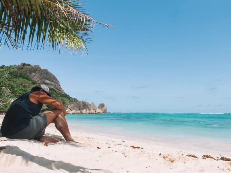 man reading on the Seychelles beach
