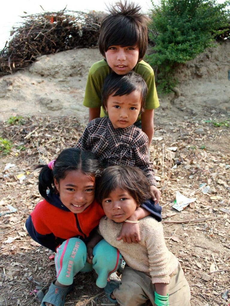 Village Children in Nepal standing together and smiling at camera