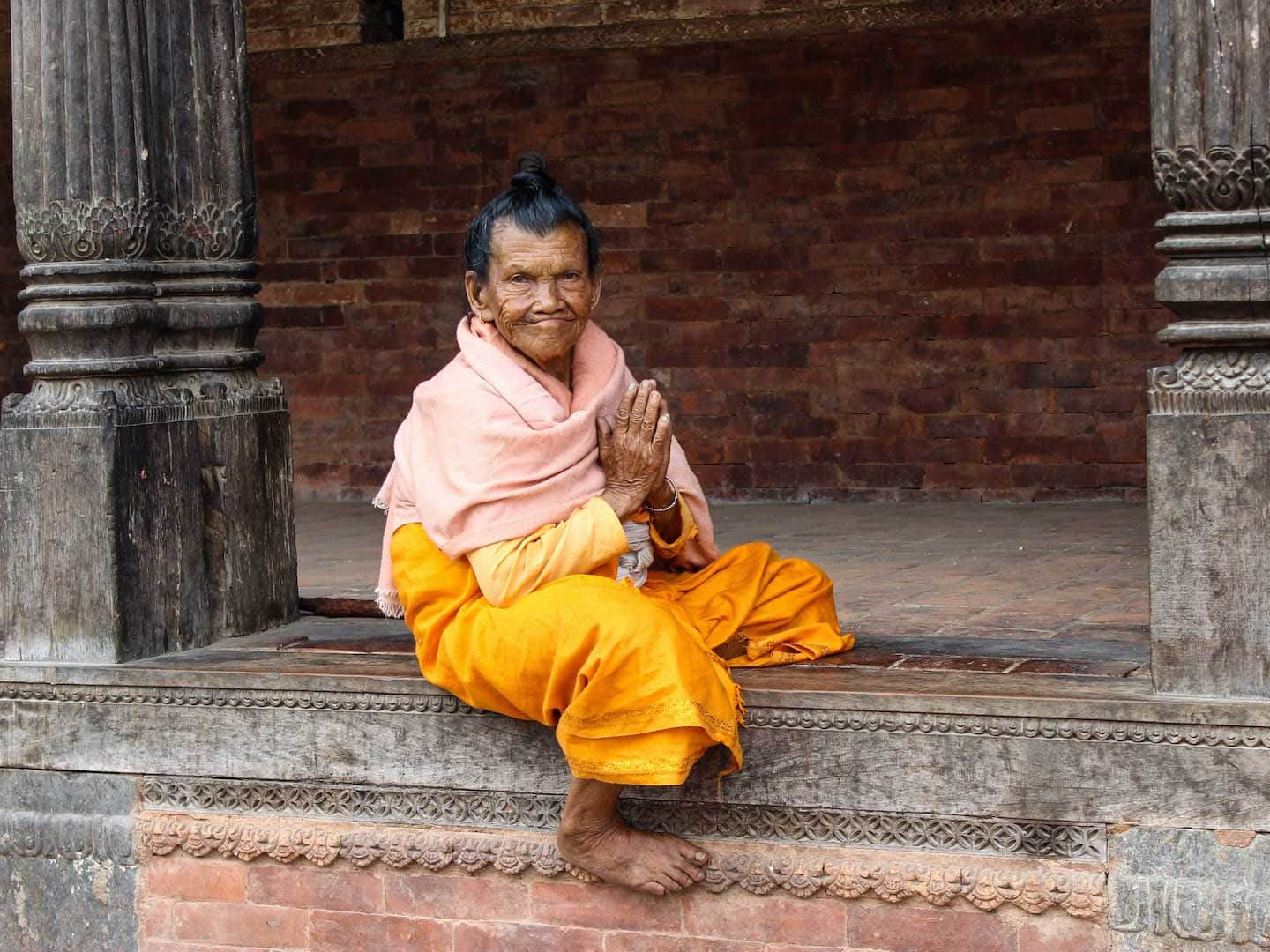 Elderly Nepalese lady holding her hands in prey position, Namaste