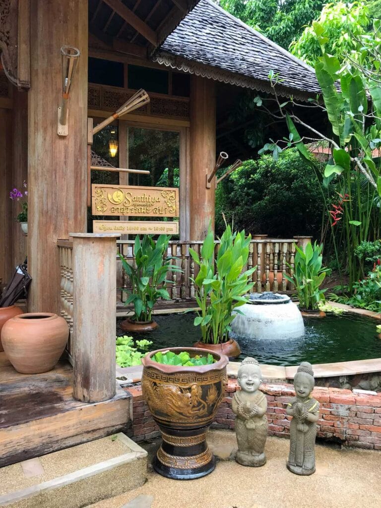 Entrance to spa at Santhiya Koh Yao Yai Resort. small pond surrounded by trees