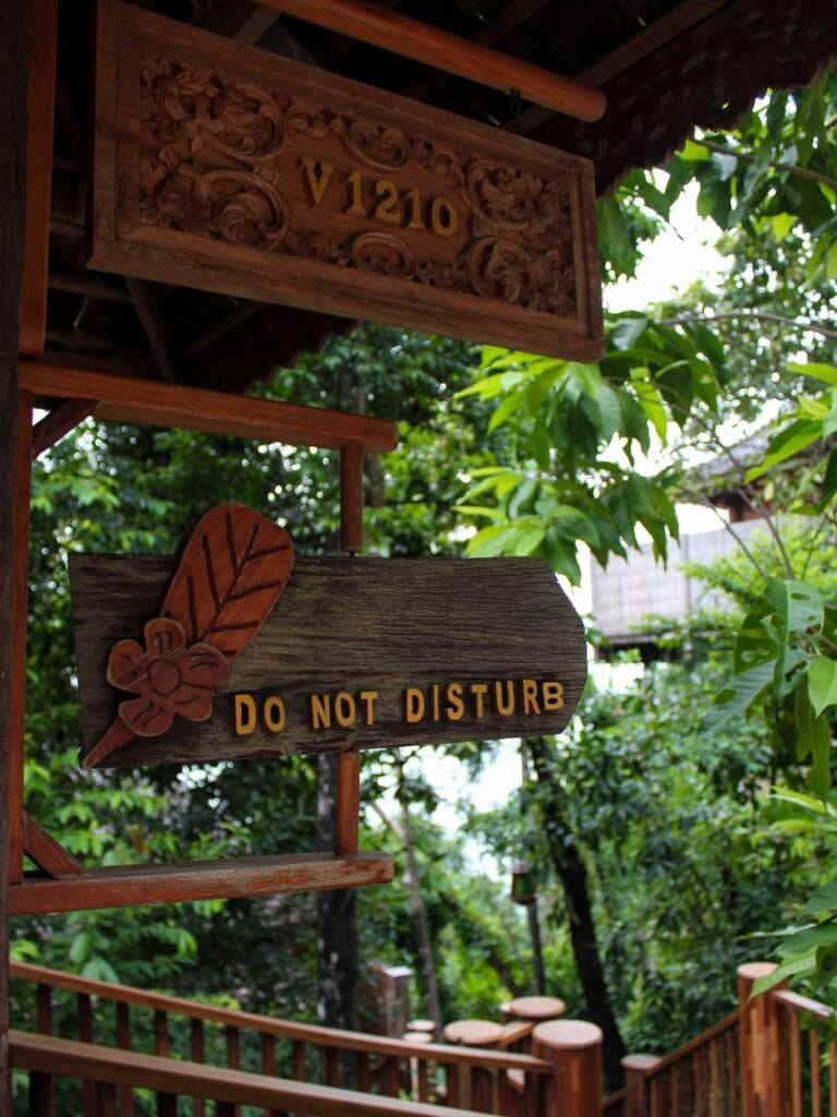 outside Thailand villa, wooden do not disturb sign. This is the entrance to an ocean villa at Santhiya Koh Yao Yai resort
