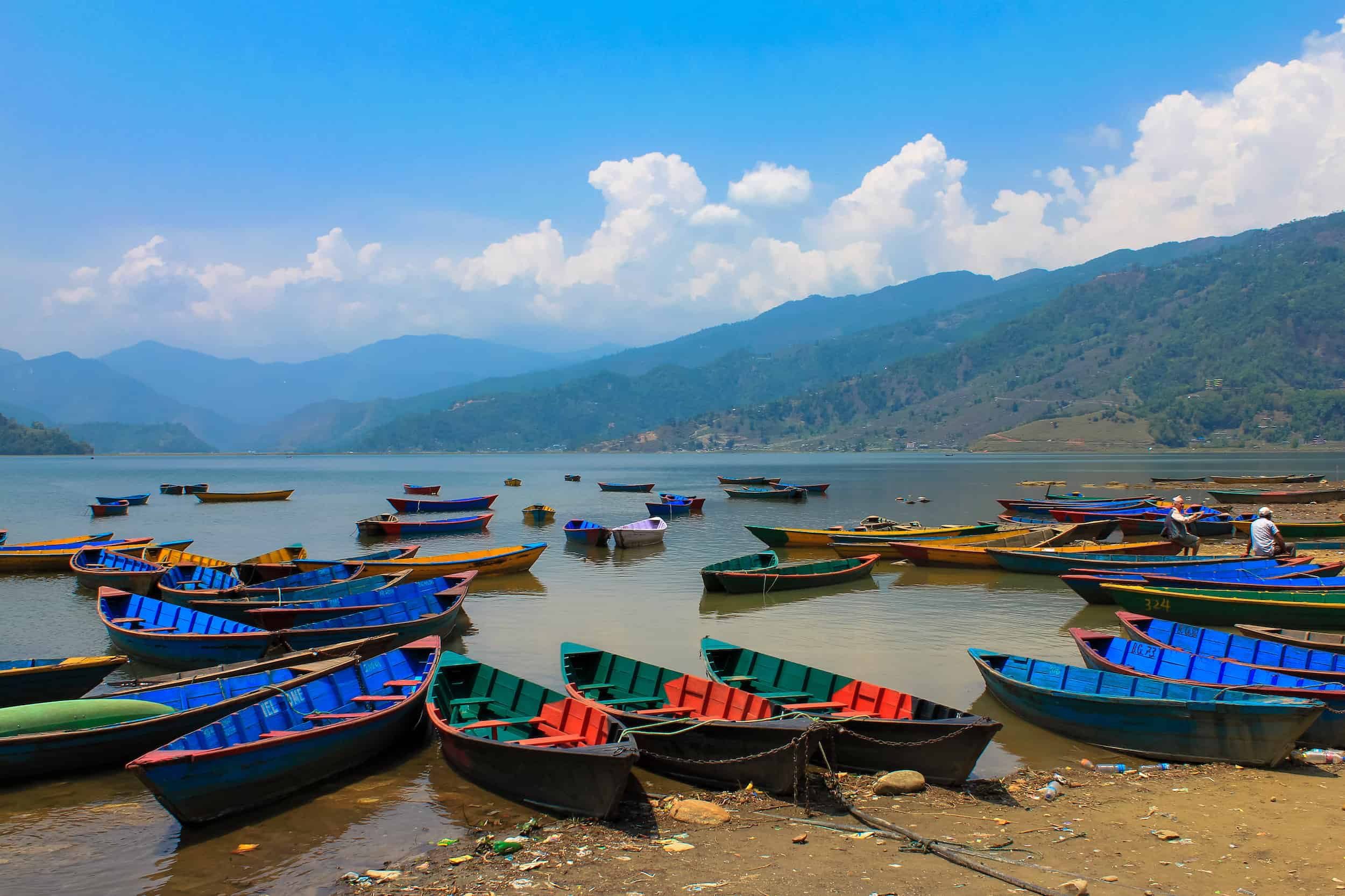 Colorful wooden row boats in edge of lake