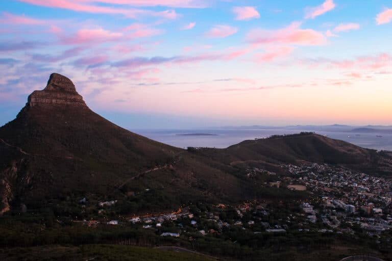 sunrise view looking towards lions head and the city of Cape Town, with the ocean in the background