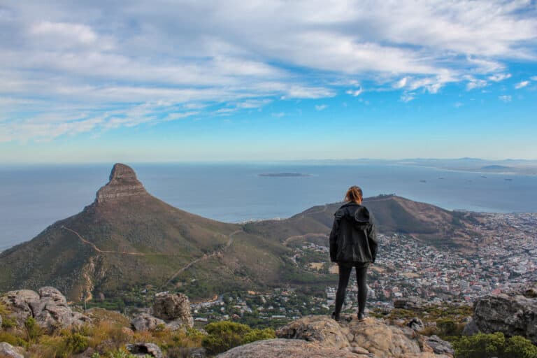 I'm standing on the edge of mountain looking out to the city and the Atlantic Ocean while traveling in Cape Town