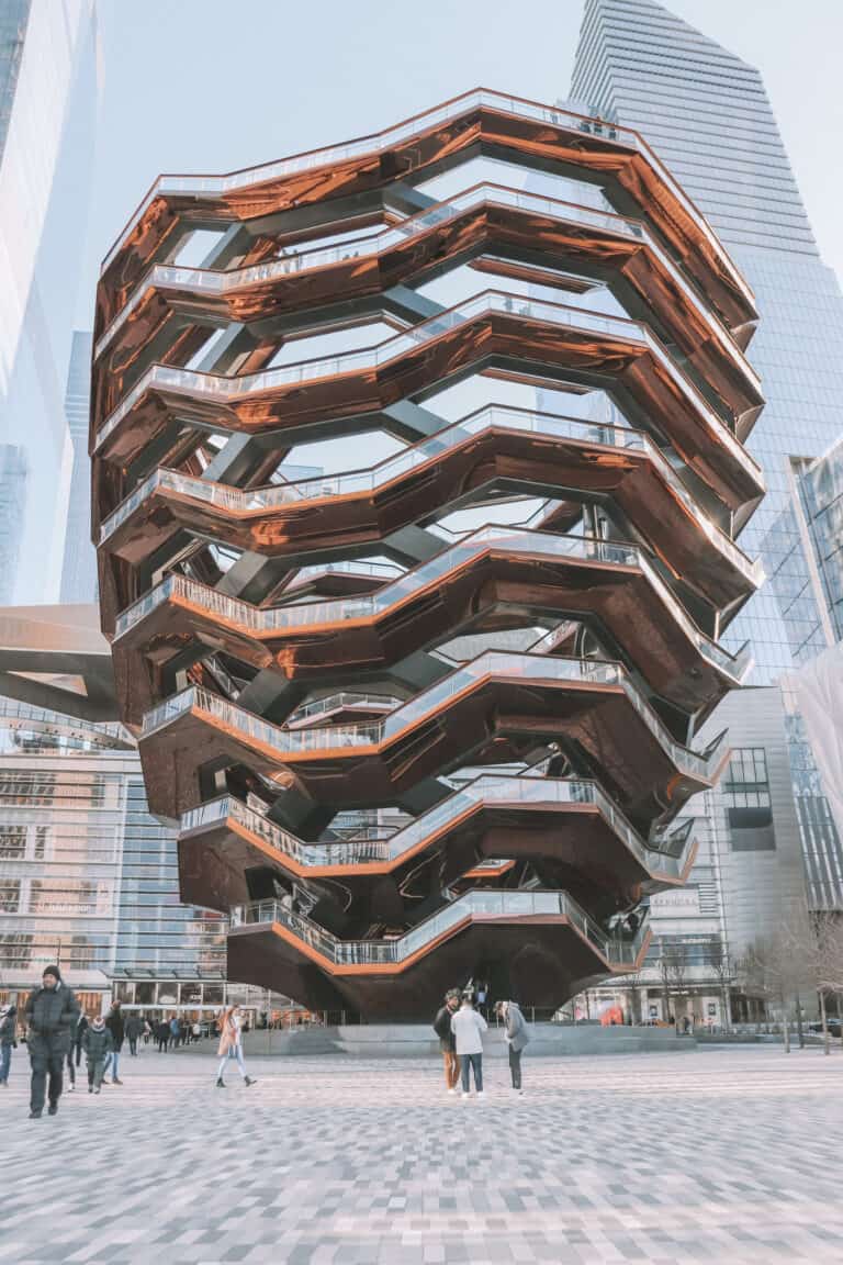 A sunny day in New York City, the main focus in this photo is a large circular staircase structure called the vessel, this is free to enter