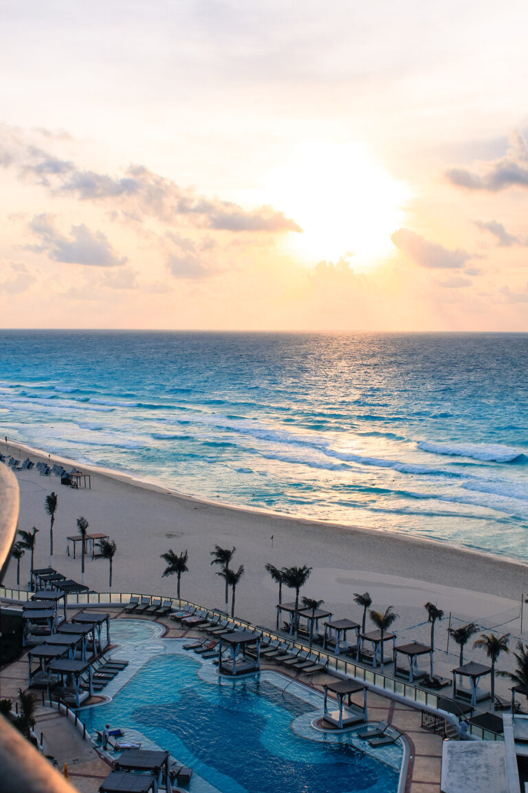 Taken from a hotel balcony in Cancun, looking out to the ocean at sunrise. The hotel pool and bar can be seen below.