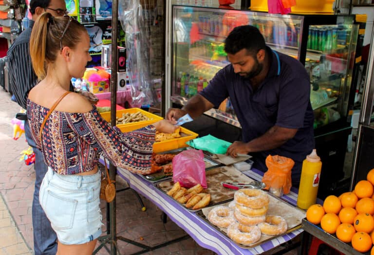 Elyse purchasing street food snacks at a market in Kuala Lumpur