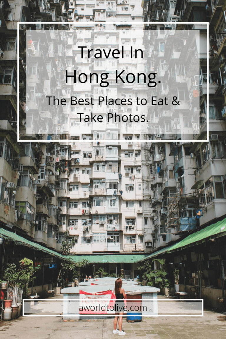 Elyse standing looking up at three densely populated apartments buildings. Over image is text saying; Travel in Hong Kong, the best places to eat and take photos