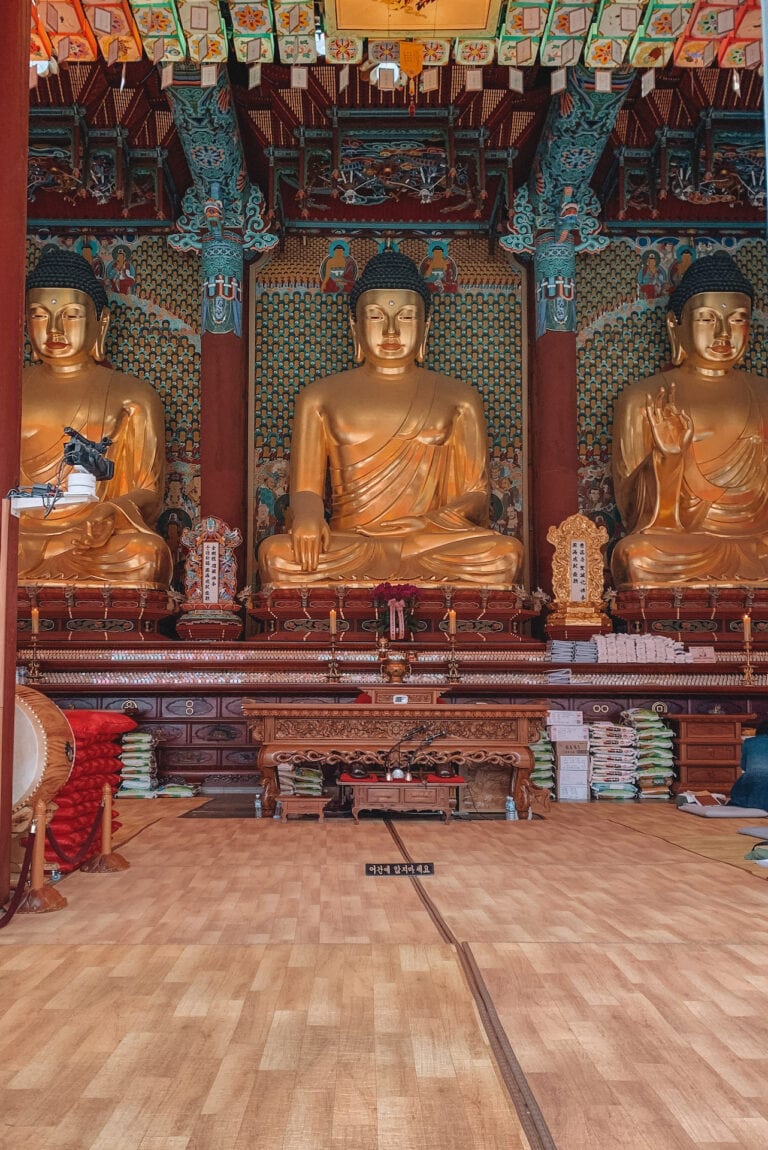 Three gold Buddha statues inside Jogyesa Temple in Seoul