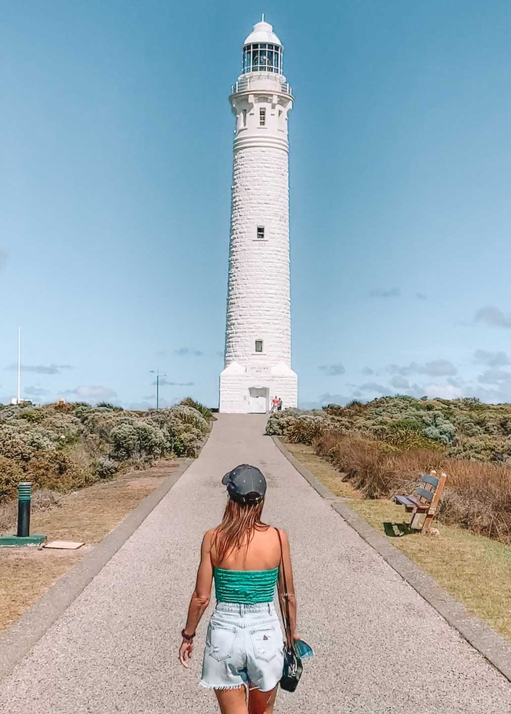 Elyse walking towards Cape Leeuwin Lighthouse in Western Australia on a sunny day. One of the fun things to do in Margaret River