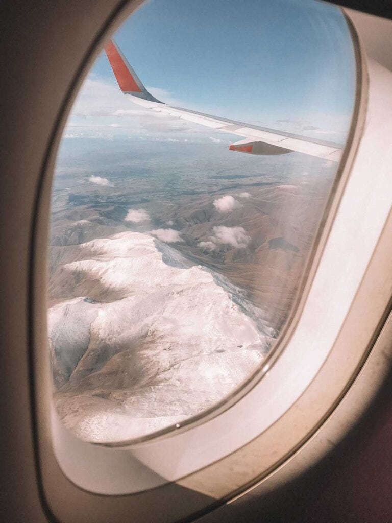 Taken from a plane window at high altitude. Jetstar Australia flight. Flying of snow covered mountains in New Zealand.