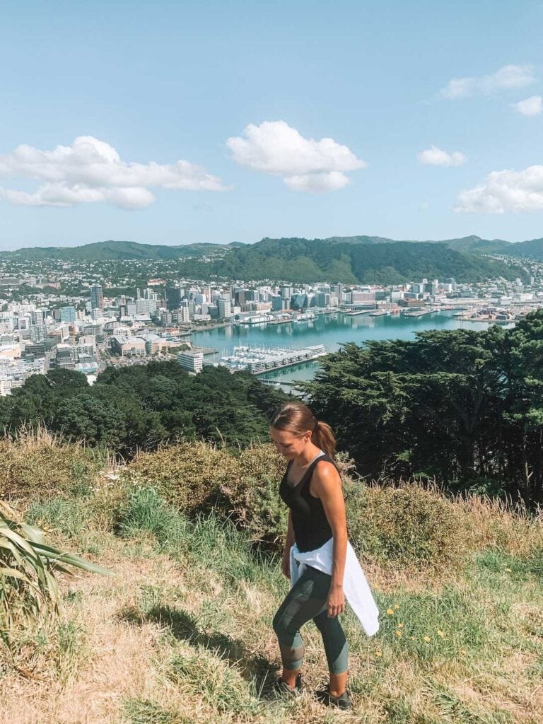 Elyse standing at the peak of Mount Victoria in Wellington. One of the free things to do in Wellington is hiking.