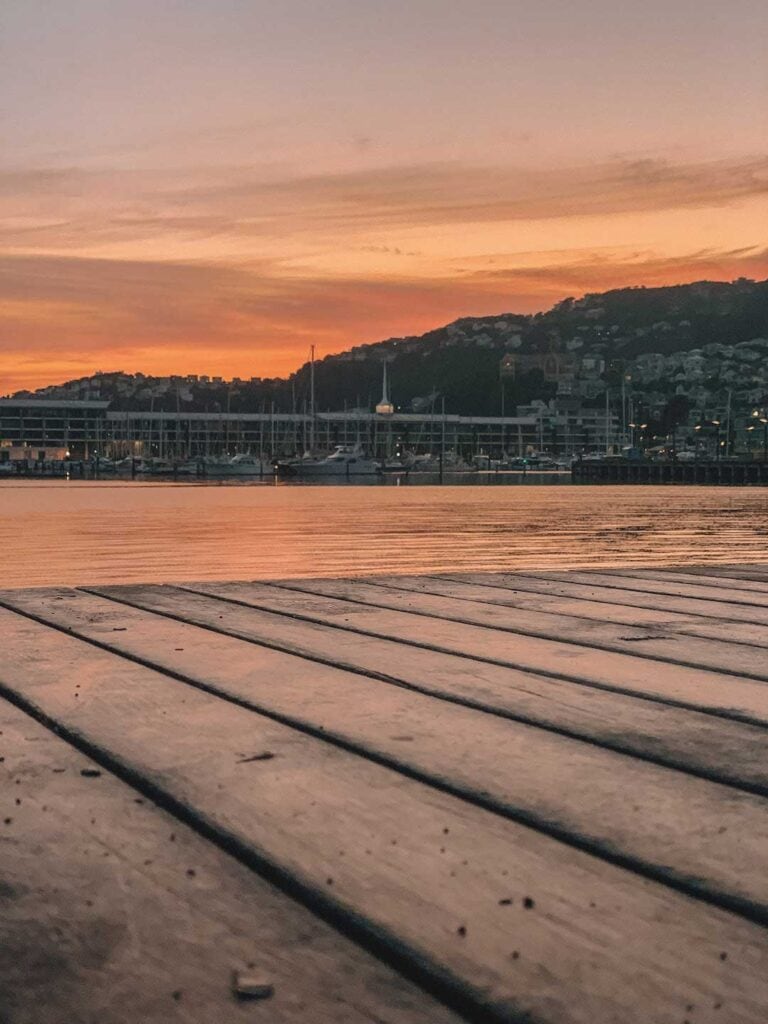 Wellington waterfront sunrise, facing the boat harbor with the sun rising in the distance.