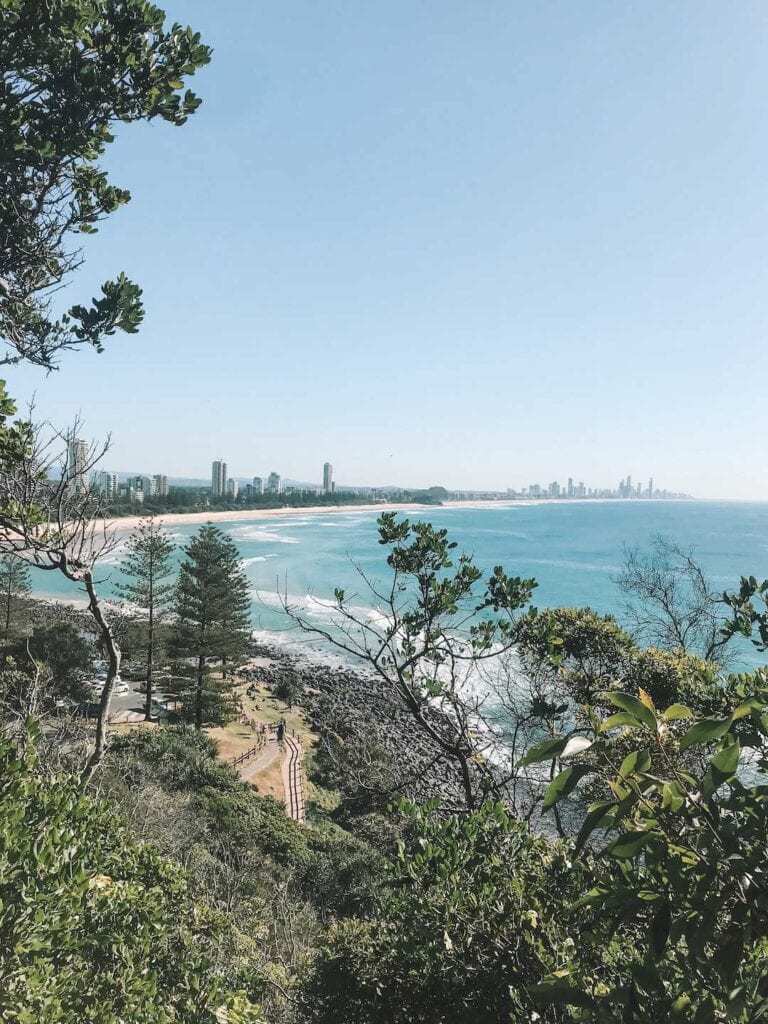 A view of Burleigh Heads Beach and Surfers Paradise skyline is in the distance