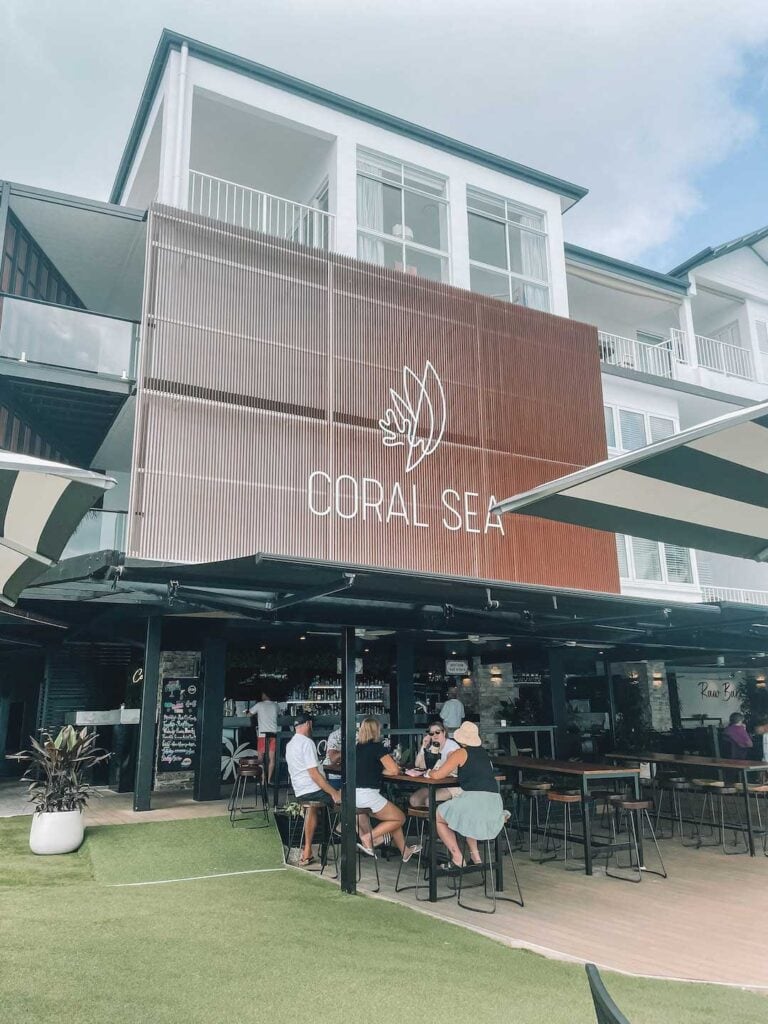 A group of friends enjoying drinks at the bar at Coral Sea Resort