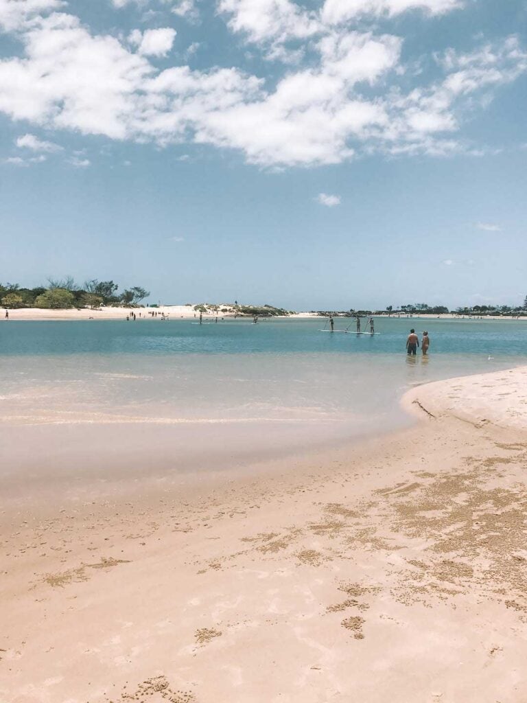 A sunny day at Currumbin Creek with people enjoying water activities. This is one of the best beaches on the Gold Coast