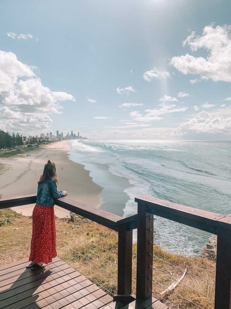 Elyse standing on the wooden lookout in North Burleigh looking at the view of Nobby Beach