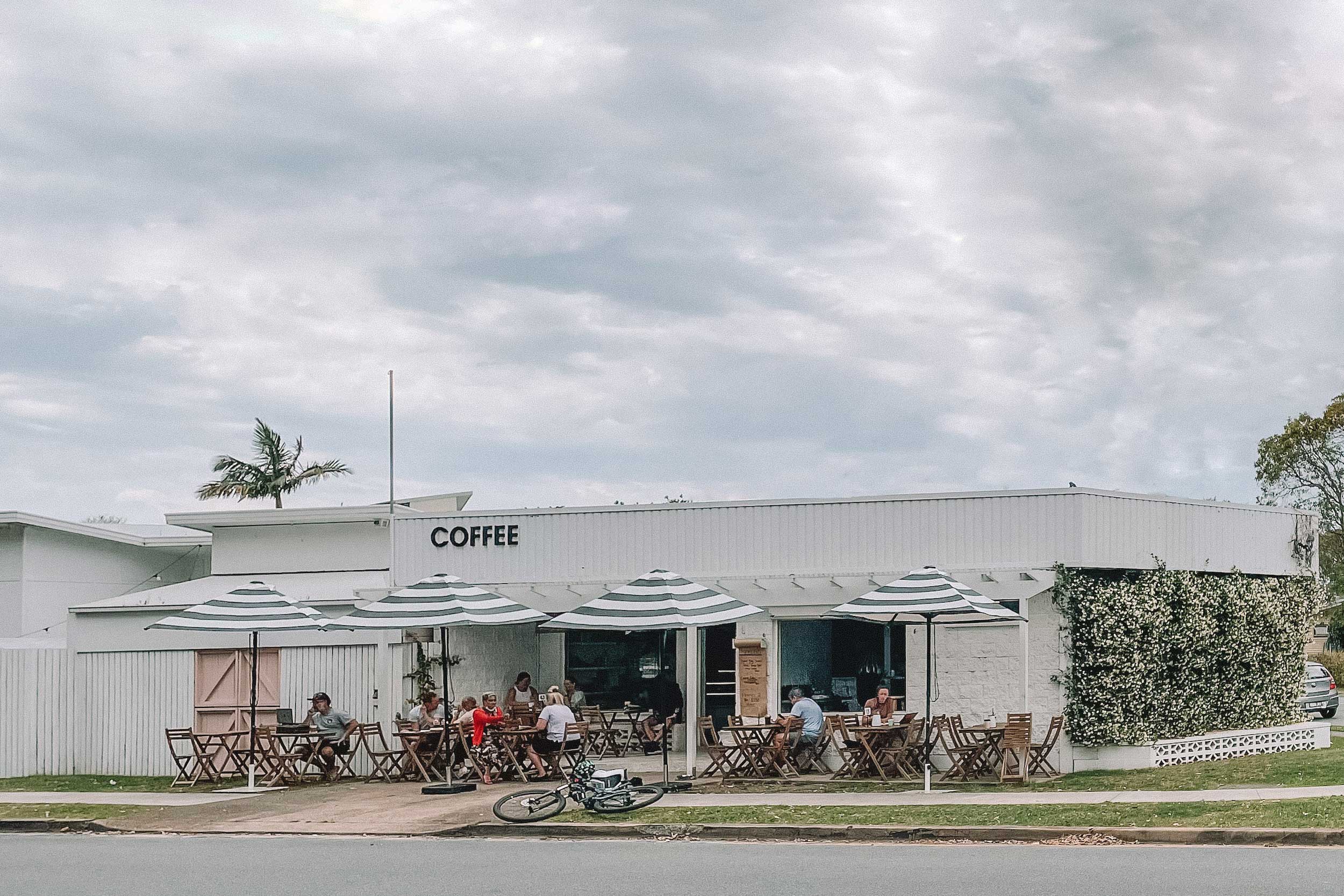 A bust cafe in Tweed Heads on a cloudy day. Next Door Espresso is located on a corner block and there is heaps of seating out the front