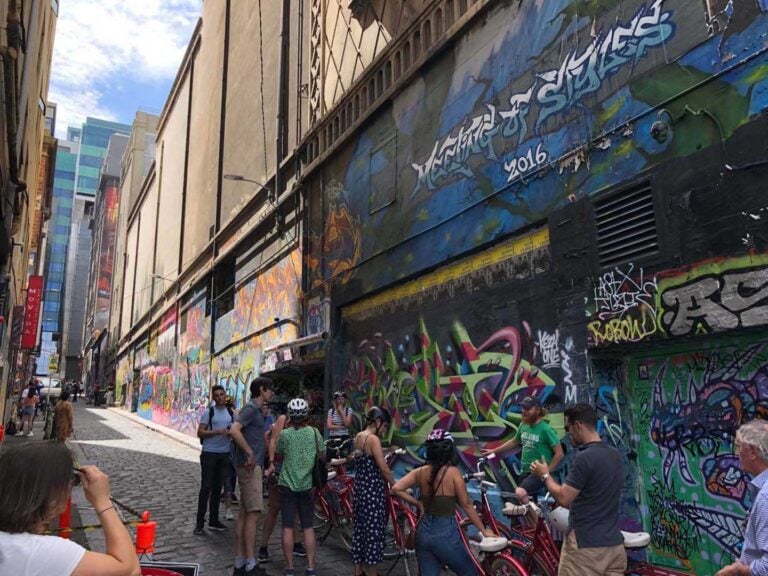Tourist admiring the famous street art / graffiti in Melbourne CBD