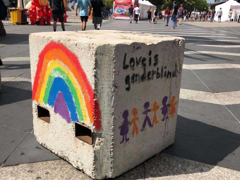 A concrete block in Melbournes city, with hand painted street art on it