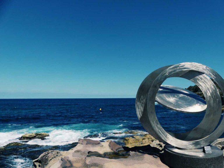 Sydney's Sculpture Walk, a large silver sculpture on the oceans edge