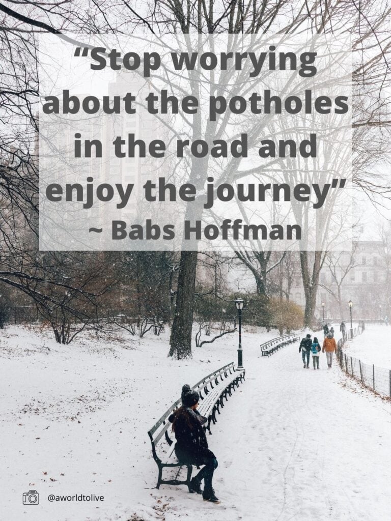 Elyse sitting in Central Park during winter, the whole park is covered in snow. Travel quote written over image