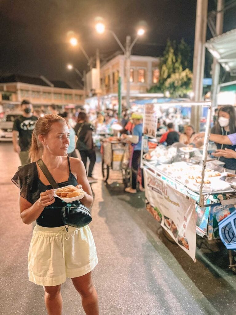 Elyse eating street food in Thailand