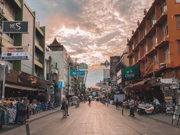 The sun setting behind the signs along Khao san road
