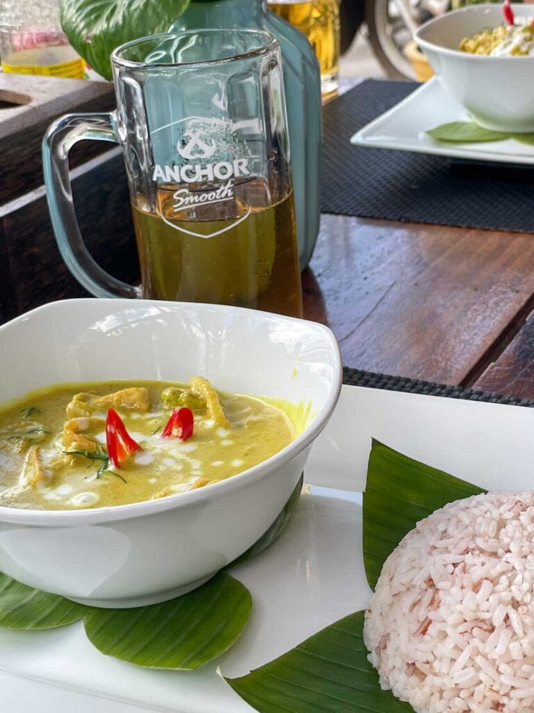 A serving of Amok curry and a local beer in Cambodia. Q&A guide on what is the best currency to take to Cambodia