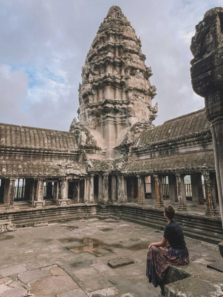 Elyse sitting in the temples of Angkor Wat