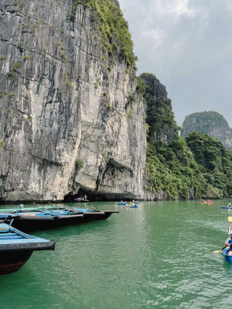 tourist kayaking into Luon Cave in Vietnam