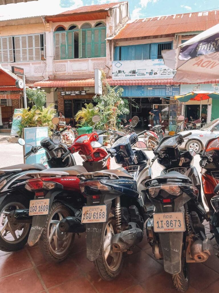 Scooters parks at the shop in Kampot