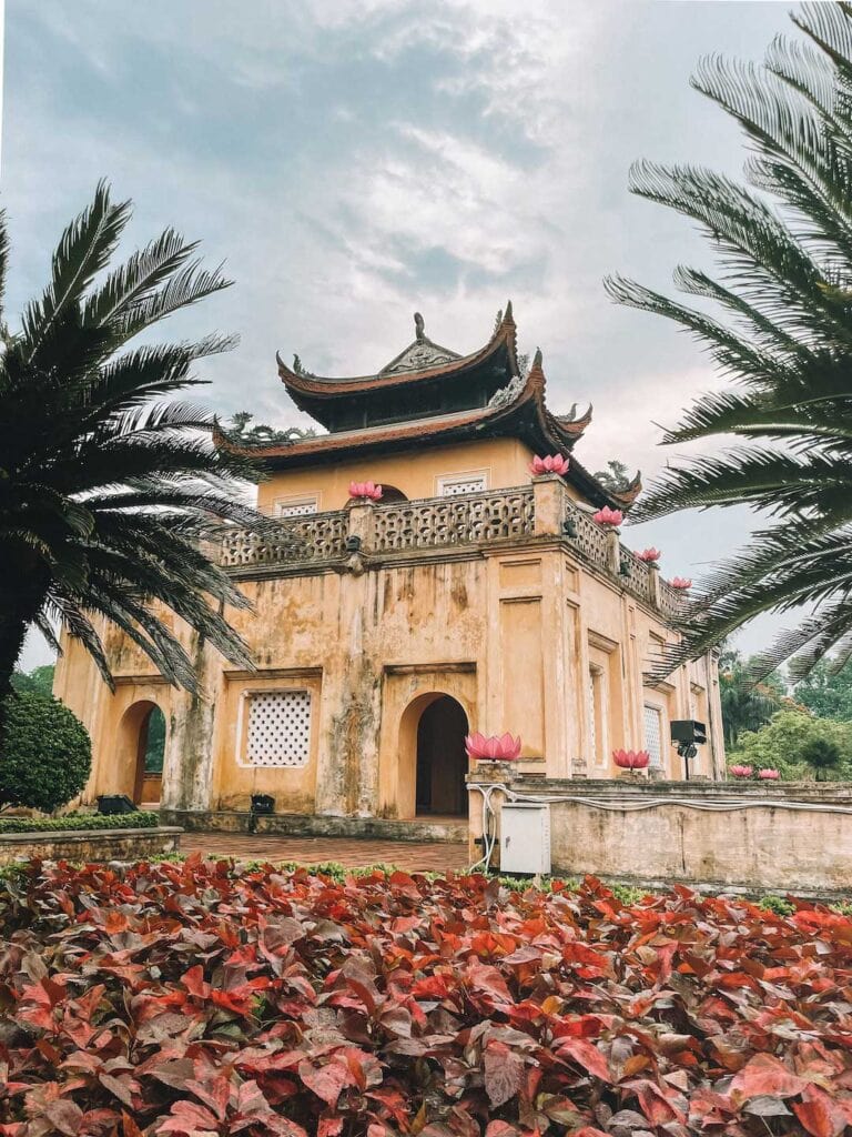 An image of the main part of the citadel in Hanoi. The acient building is yellow and surrounded by beautiful gardens. A recommend site during one week in Hanoi