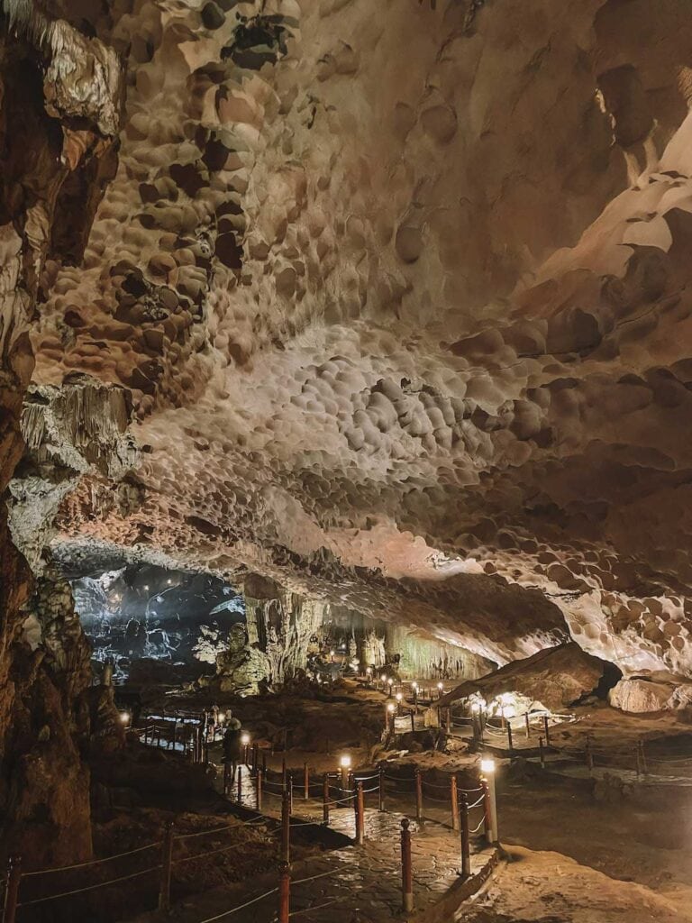 In side a cave in Halong Bay. The cave is very deep and lit up by lights positioned along the path for tourists to walk along