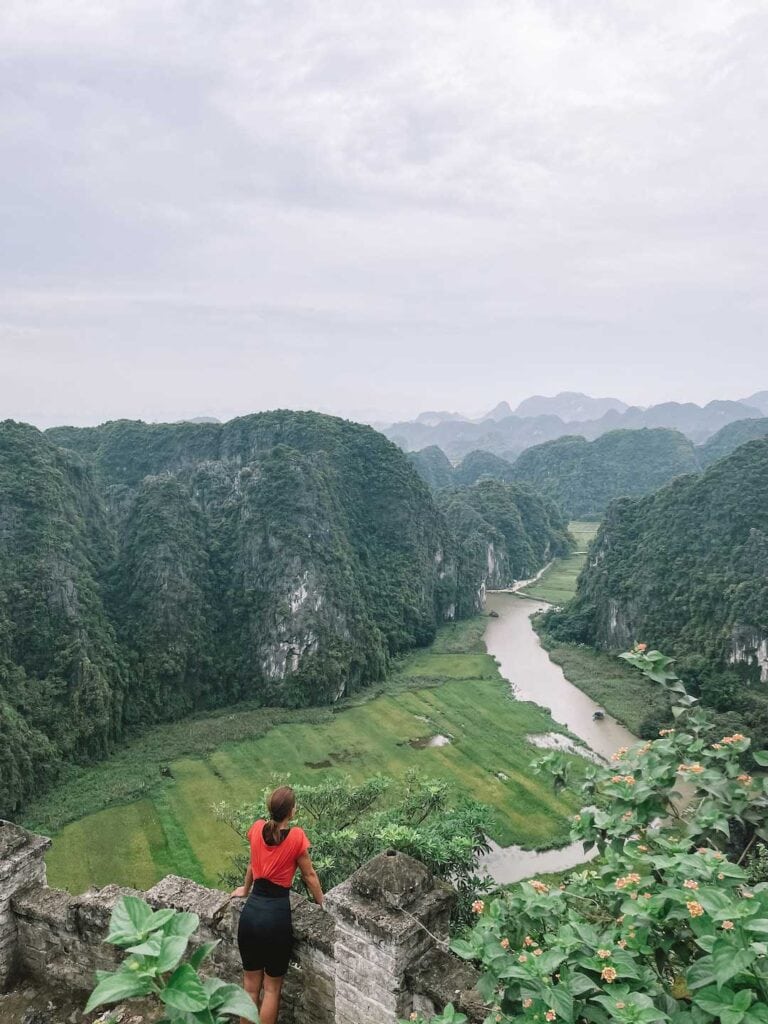 Elyse at the top of the viewpoint looking out at Tam Coc river in Ninh Binh, suggested activity on this north Vietnam itinerary