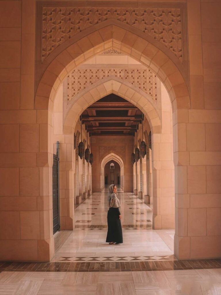 Standing in the walkways of the grand mosque in Muscat