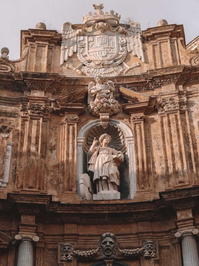 Statue of a Saint on one of the four corners in Palermo. This guide answers the question, is Palermo worth visiting