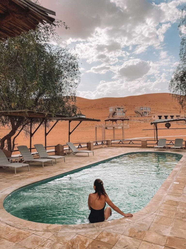 Sitting by the pool at thousand nights desert camp in Oman