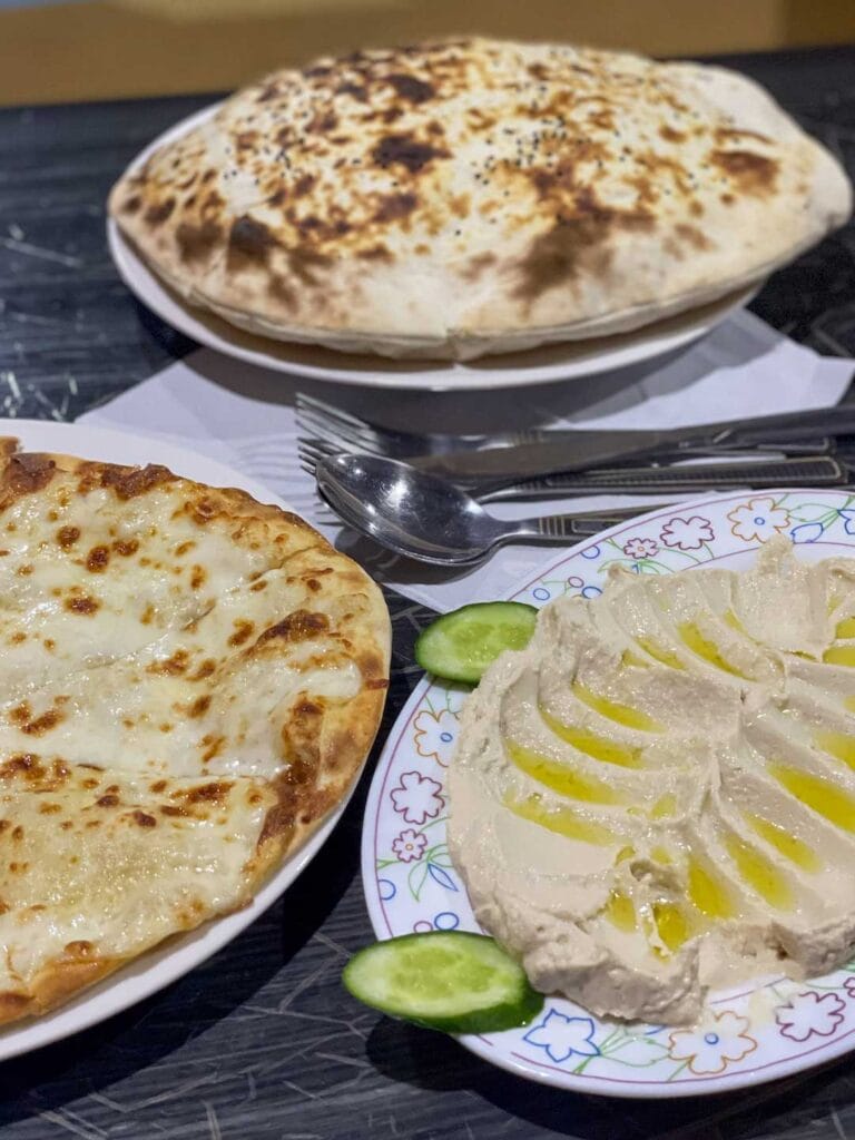 Additional Omani food, including hummus and bread