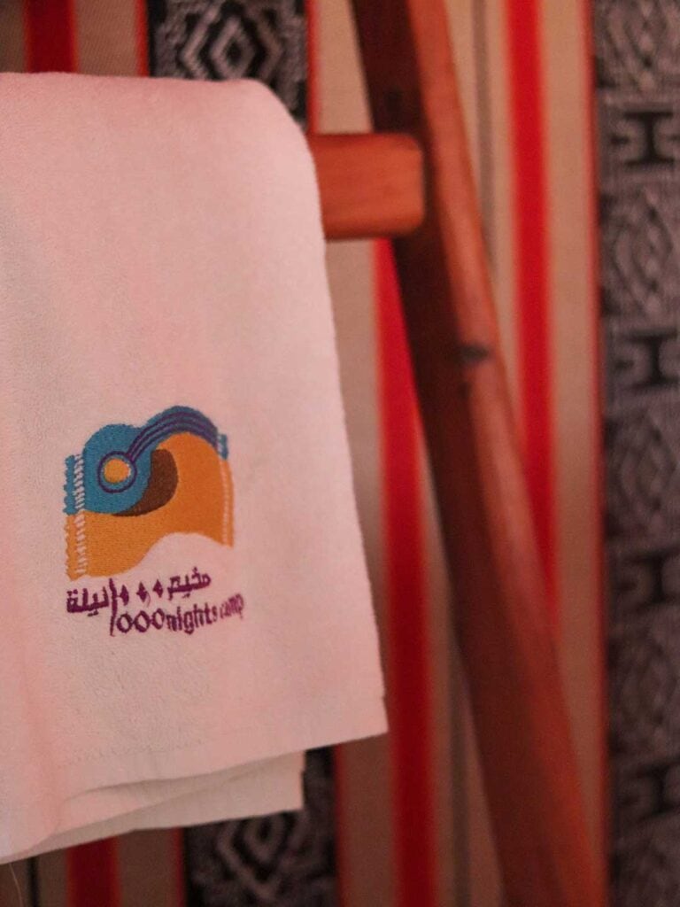 close up of the embroidery of the bath towels at Thousand Nights Sharqiya Sands Camp