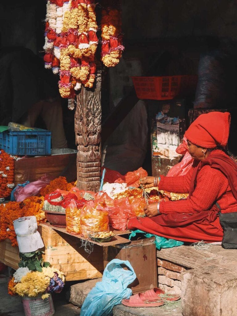 local Nepalese women preparing flowers for the temple