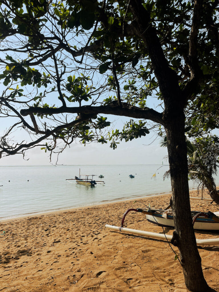 Sanur local beach and traditional boats close to shore