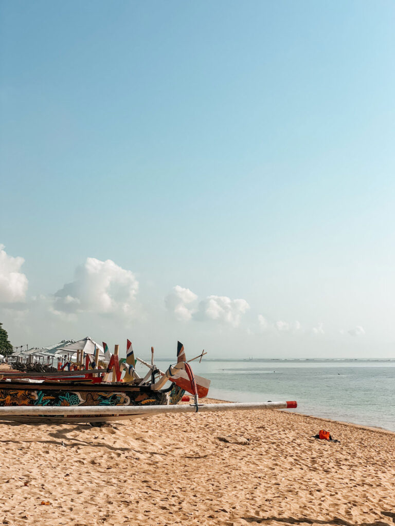 wooden boats on the sand at Sanur Beach