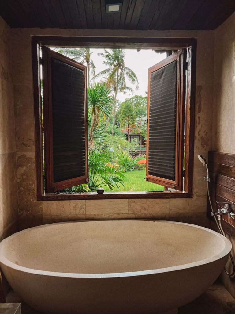 Large bath with windows opening up to views of the rice terrace, Bali