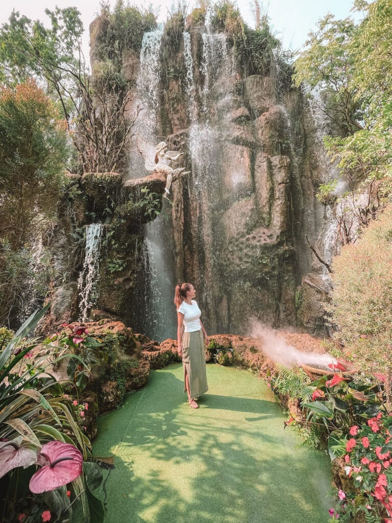 Elyse stands in front of main waterfall in Lalitta Cafe, Chiang Rai
