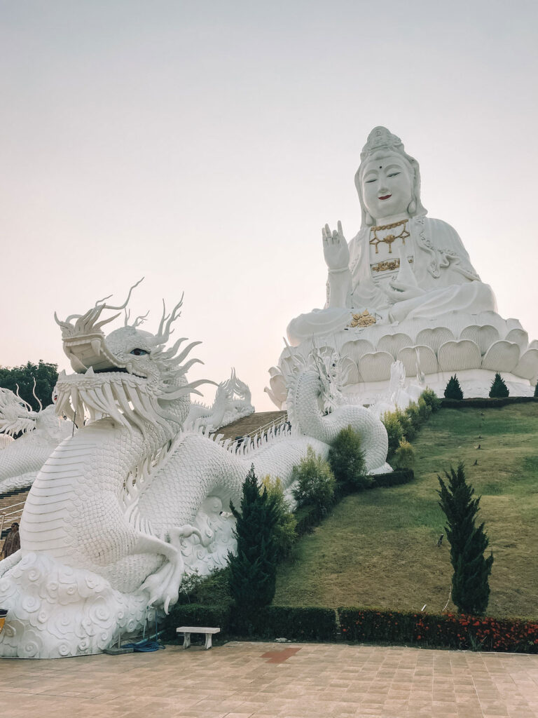 Beautiful white stair case at Wat Huay Pla Kang, Chinag Rai, along the stair case is a statue of a Dragon and at the top is a big statue of a goddess