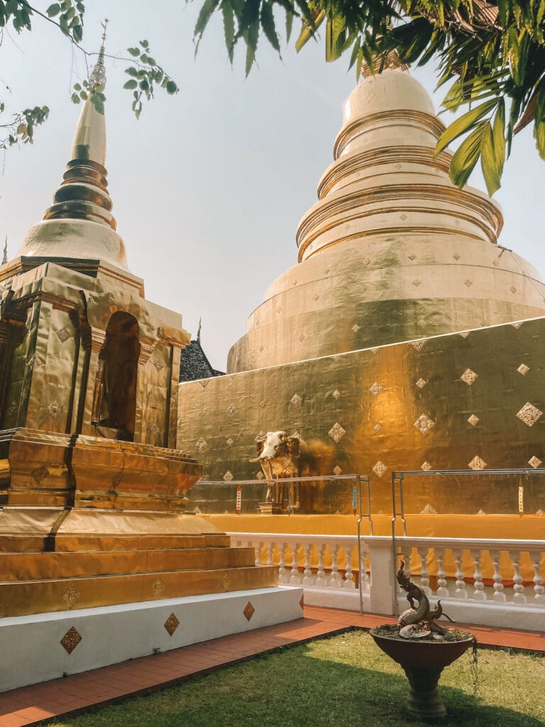 Golden statues and pagodas inside Wat Phra Singh Temple in Chiang Mai