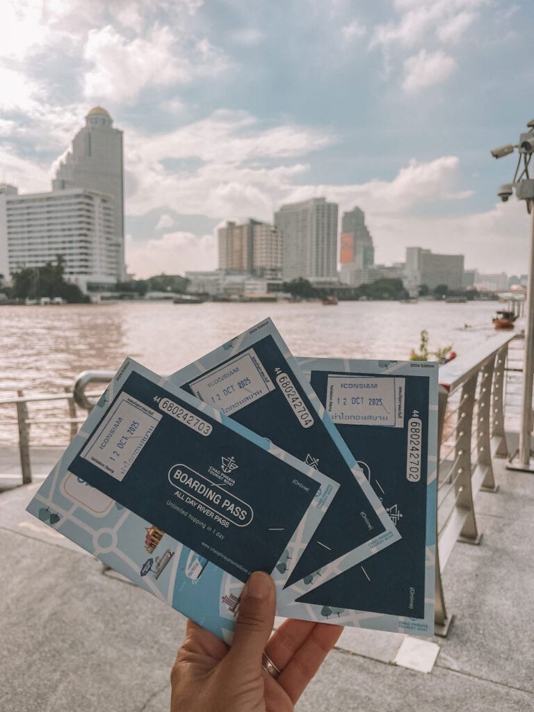 holding up the day passes for the Hop on Hop off boat in Bangkok